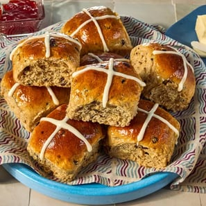 Traditional spiced, sticky glazed fruit buns with pastry crosses