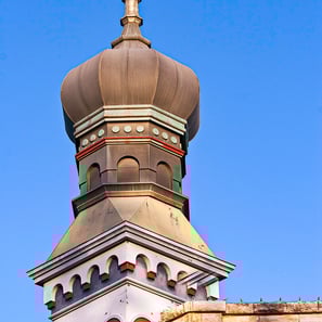 Historic Georgetown, Texas building featuring iconic onion dome architecture under a bright blue sky.