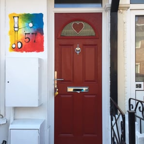 narrow red composite door with bespoke heart glass