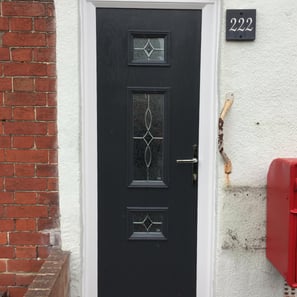 a thin front door fitted on a terrace house in Portsmouth by buildmydoor. black Dorn with pattern glass.