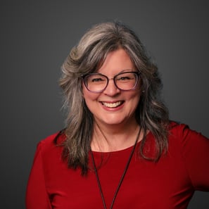 a woman with glasses and a red shirt