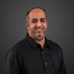 A man in a black button up shirt