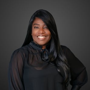 a woman with long black hair and a black blouse
