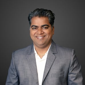 a man in a grey suit and white shirt