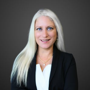 a woman with white hair and a black blazer