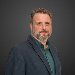 a man in a suit and green shirt