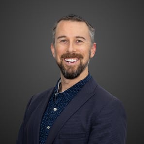 a man with a beard and navy suit
