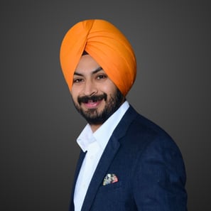 a man in an orange turban and navy suit