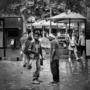 Peter Pickering, on Perth's streets, captures an exchange by two aboriginal men.