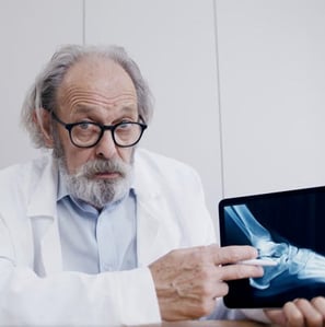 Male Doctor Discussing a Foot Xray and Link to AnatomyVideos.com