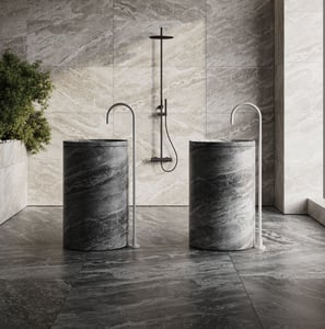 3D rendering of a modern bathroom with stone sinks, curved faucets, marble wall, shower, dark floor, and indoor plant.