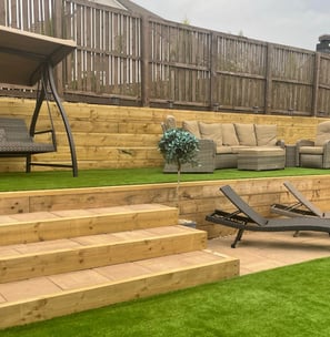 Garden with oversized stairs and double height retaining wall.