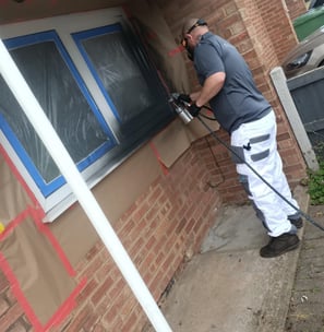 Mr Spray technician applying UPVC spray paint to ground floor windows in Worcester