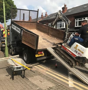 mini digger being loaded onto the back of a van in oldbury