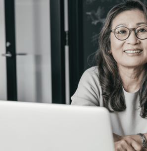 a woman sitting at a table with a laptop