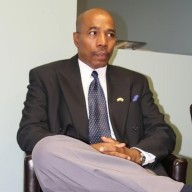 a man in a suit and tie sitting in a chair