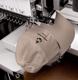 a beige cap being embroidered with anchor design