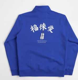 Nike SB x Fly Streetwear 1/2 zip fleece in royal blue with white accents, featuring co-branded chest logo and 'The Fragrance