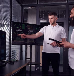 Willbert and DC Charging two men standing in front of a tv screen