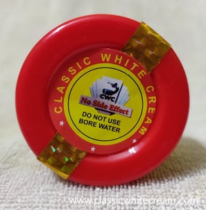 a red plastic water bottle with a red and yellow label on it