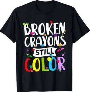 a black t - shirt with the words broken crayon's still color