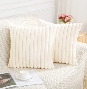 a pair of pillows with a white and black pillow
