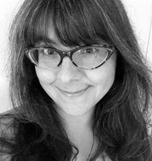 A black and white headshot of a woman in her 30s.
