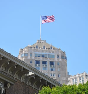 a flag flying over a building with a flag on topin san francisco