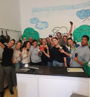 Group photo of smiling volunteers at the local soup kitchen in Portimão, Portugal