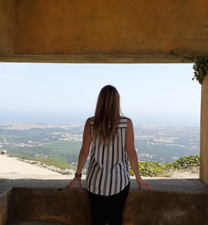 Martina looking at the view from a hilltop in Cascais, Portugal.