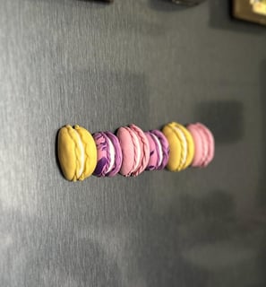 colorful half macaron fridge magnets on a grey fridge