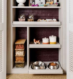 a kitchen with a brick wall and shelves with bowls of food