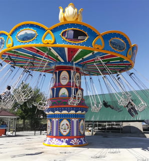 a colorfully decorated Flying Chair rides at a carnival