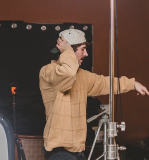 Man directing a lighting setup for a podcast in Dallas, Texas.