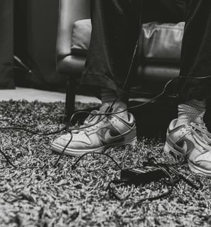 Audio cords wrapped around shoes in a podcast studio in Dallas, Texas.