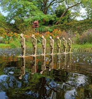 Row of small statues in a pond