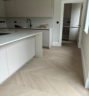 A light oak chevron floor in an open plan kitchen