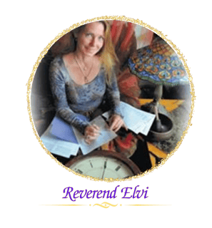Reverend Elvi sitting at a clock table doing a numerology reading.