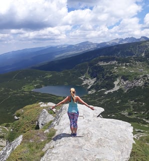 Martina with open arms in the mountains. Seven Rila Lakes.