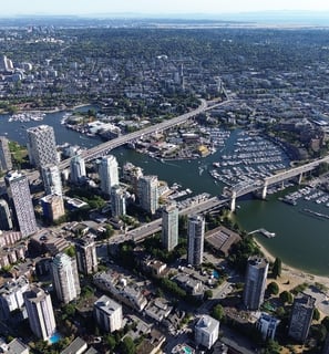 a cityscape of a large city with a bridge and a river