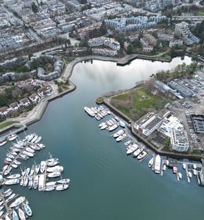 a cityscape of a harborfront with boats and buildings