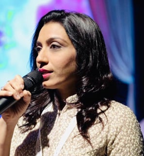 a woman in a white shirt and a microphone