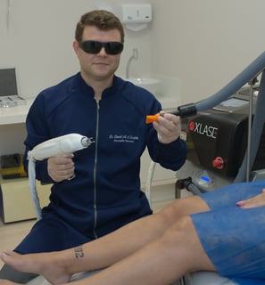 a man in sunglasses and sunglasses is sitting on a chair