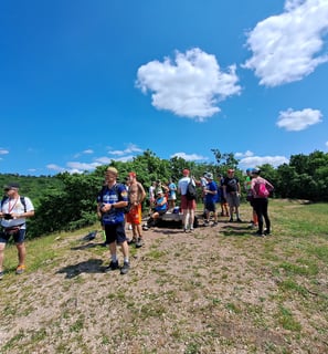people grouped on a hilltop in sunshine