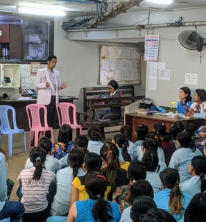 Dr Zaw giving a speech to a group of audience