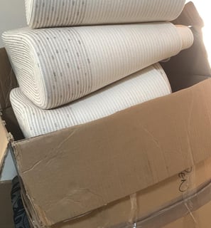a stack of boxes with a lot of bags