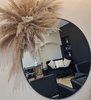 a mirror with reflection of Glacier Hair Boutique within it