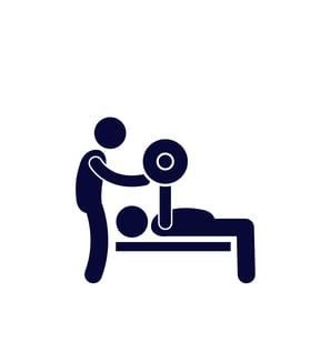 A silhouette of a personal trainer spotting his client bench pressing