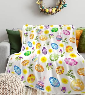 A soft, cozy flannel Easter-themed blanket with colorful egg designs, perfect for home décor
