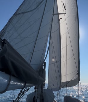 a sailboat sails the ocean on a sunny day
